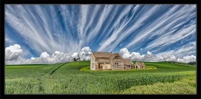clouds and abandoned farm house